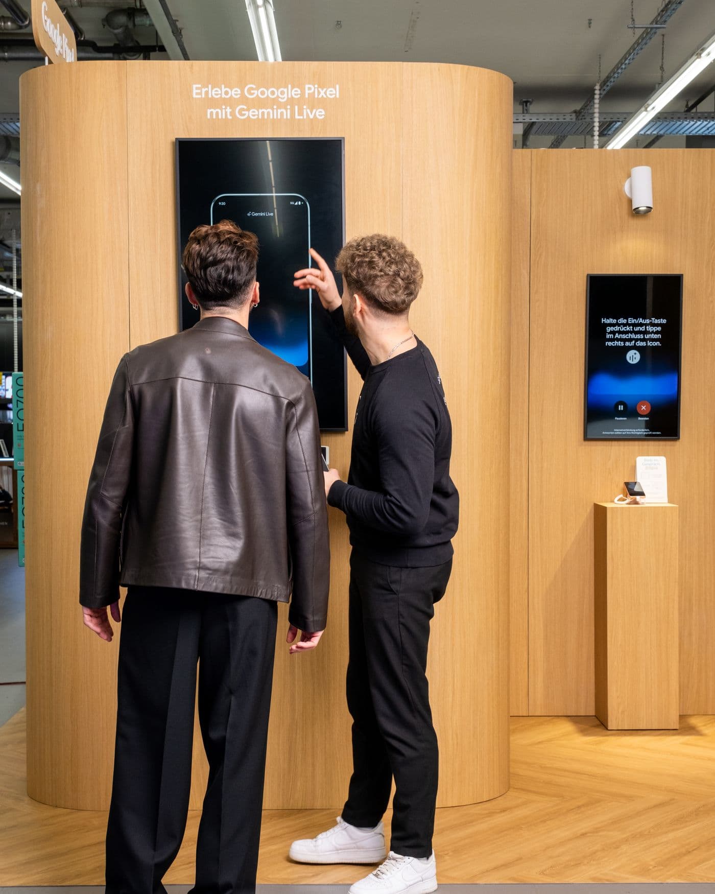 A specialist walking a visitor through Gemini Live on the demo wall of the brand space